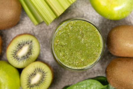 Green smoothie of celery, kiwi, green apple and spinach in a glass.の写真素材
