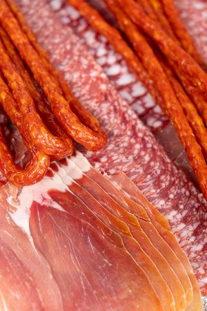 Various cold meat appetizers - Spanish ham cerrato, salami, sausages.