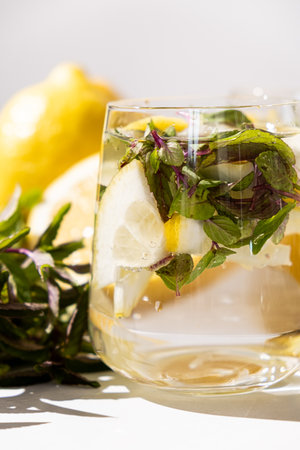 A glass of refreshing lemon water with mintの写真素材