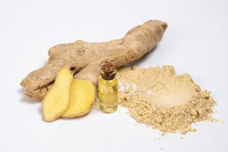 Spice ground ginger and ginger root on a white isolate background