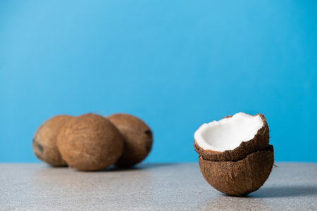 Coconuts on blue background, space for textの写真素材