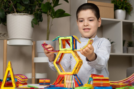 A child plays with a magnetic construction set. Interesting educational toys.の写真素材
