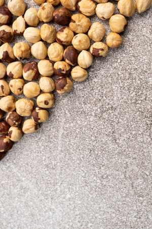 Roasted hazelnuts on a gray stone background top view, place for text.の写真素材