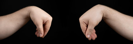 Comparison of healthy arm and arm with wrist ganglion cyst on black backgroundの写真素材