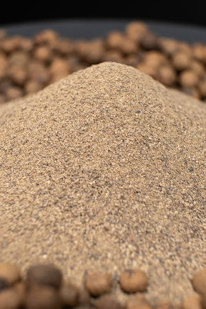 Ground black pepper and peppercorns close-upの写真素材