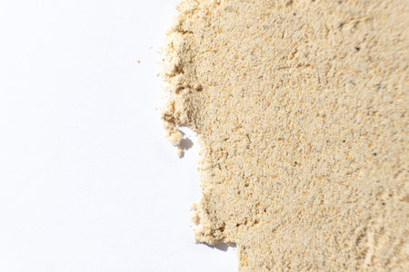 Macro spilled ginger powder, ground ginger root on a white background.の写真素材