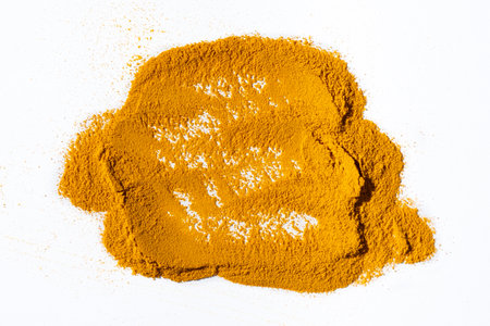 Scattered ground turmeric root on white background, spice texture.