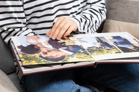 Woman Looking Wedding Photo Book with Wedding Photos, Happy Memories.の写真素材