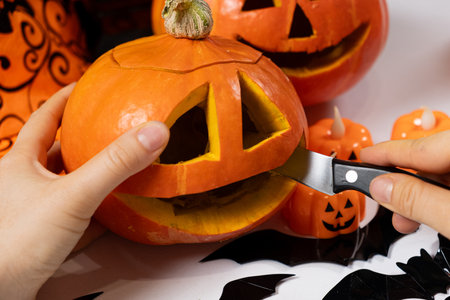 Creating a Hokkaido pumpkin jack-o'-lantern for Halloweenの写真素材