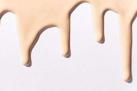 Flow foundation on a white background, art in cosmetics
