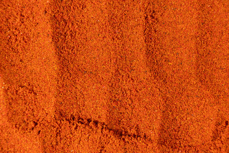 Ground paprika, red terracotta spice background, art in cookingの写真素材