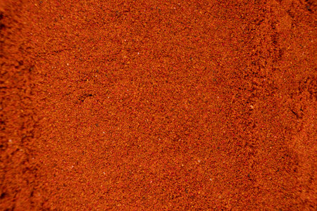 Ground paprika, red terracotta spice background, art in cookingの写真素材