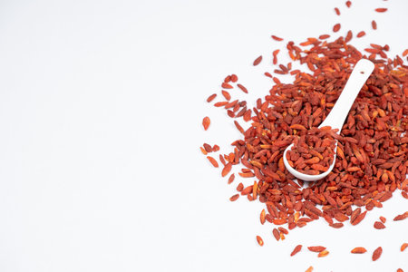 Dried Goji berries Lycium barbarum in a spoon on a white background.の写真素材