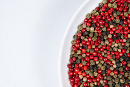 A mixture of different peppercorns on a white background, top view, copy space for text.の写真素材