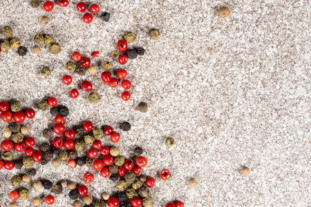 Multicolored peppercorns on a stone gray backgroundの写真素材