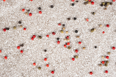 Multicolored peppercorns on a stone gray backgroundの写真素材