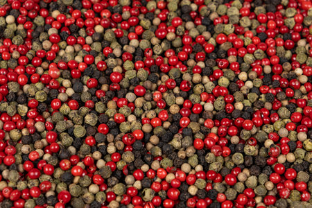 A mixture of different peppercorns white, black, red and green peppers spices