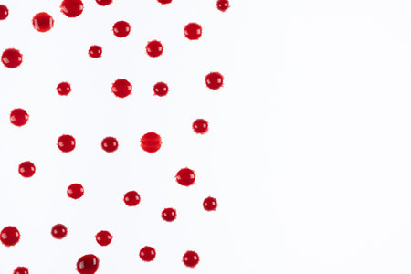 Abstract red and white background. Drops of red paint with space for text.の写真素材