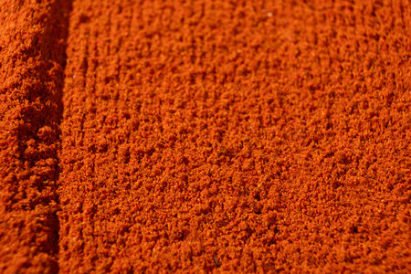 Ground paprika, red terracotta spice background, art in cooking.の写真素材
