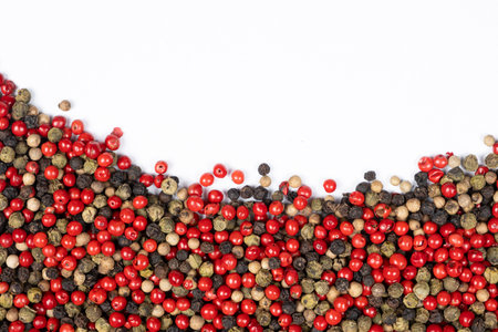 Red, green, white and black peppercorns on a white background, copy space for text.の写真素材