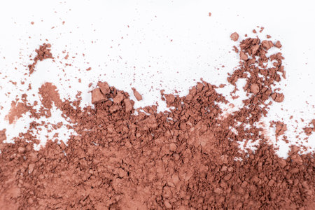 Scattered brown eyeshadow on a white background. Eye shadow textureの写真素材