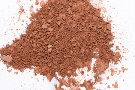 Scattered brown eyeshadow on a white background. Eye shadow textureの写真素材