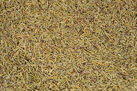 Background crushed dried rosemary leaves top view, seasoning textureの写真素材