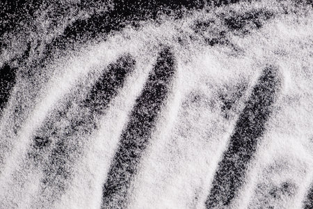 Finely ground stone white rock salt texture on black background, top viewの写真素材