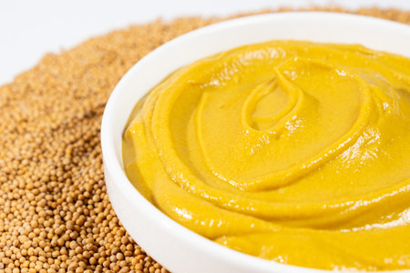 Mustard sauce and dry mustard seeds close-upの写真素材