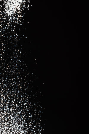 Abstract black and white background of pouring flour, space for textの写真素材