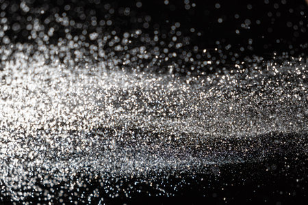 Abstract black and white background of pouring flour, space for text.の写真素材