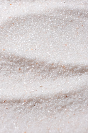 Natural Himalayan Pink Salt Fine Ground Top View Abstract Texture Vertical Background.