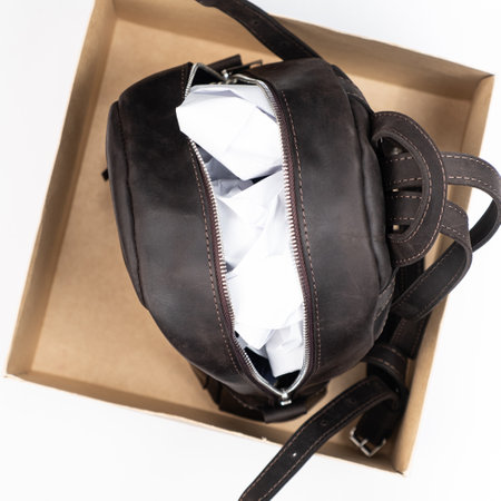 Proper storage of leather accessories. Backpack with paper inside in a boxの写真素材