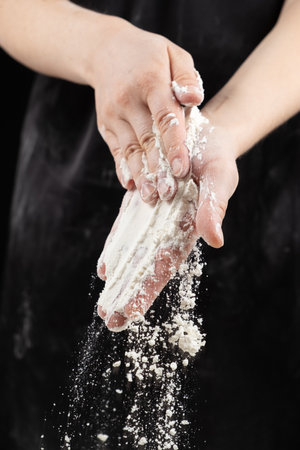 The texture of white wheat flour, the flour spills out of the cooks handsの写真素材