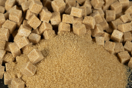 Brown cane unrefined demerara sugar in the form of crystals and cubes.の写真素材