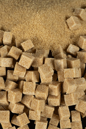 Brown cane unrefined demerara sugar in the form of crystals and cubes.の写真素材