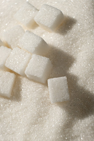 White refined beet sugar in the form of crystals and cubes