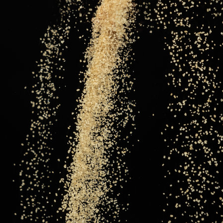 Macro Cane Brown Sugar Flow on Black Background.の写真素材