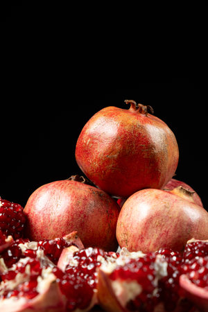 Ripe pomegranates, peeled and whole, the concept of benefits and vitamins in fruitの写真素材