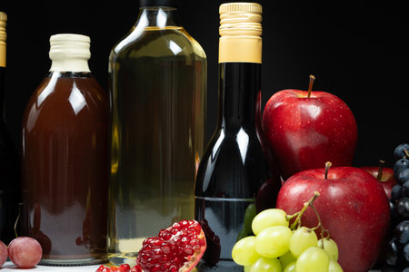 Different types of vinegar. Pomegranate, apple and balsamic vinegars in bottles.