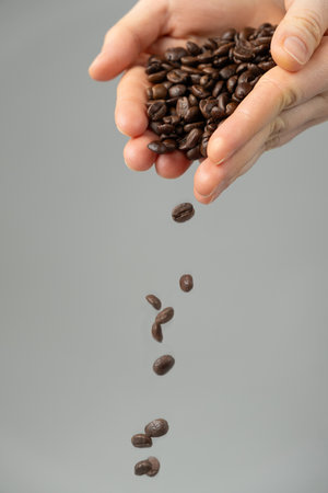 Hands Pouring Decaffeinated Coffee Beansの写真素材
