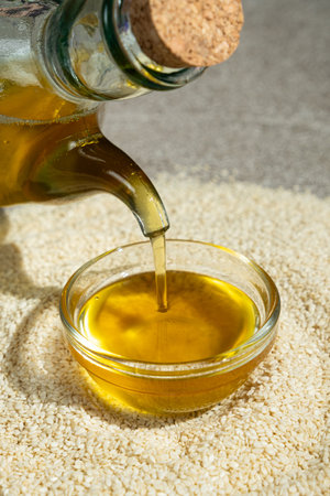 Unrefined cold-pressed sesame oil poured into a glass bowl.の写真素材