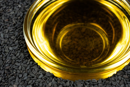Unrefined cold pressed sesame oil in a glass bowlの写真素材