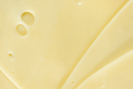 Semi-hard cheese close-up, thin slices, top view.の写真素材