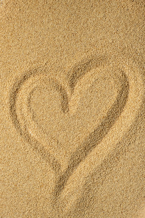 Heart on scattered amaranth seeds. The concept of a healthy and varied dietの写真素材