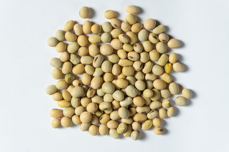 Organic raw soybeans close-up vegan superfood on white background top view.