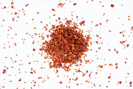 Hot chili peppers crushed and dried, natural seasoning on a white background.の写真素材