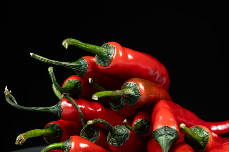 Close-up of red chili peppers with green stemsの写真素材