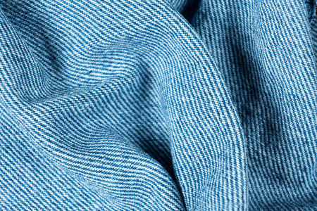 Wavy Pattern of Blue Jean Fabric. Close-Up Textured.の写真素材