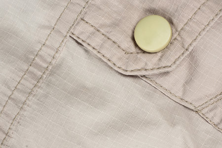 Macro beige clothing, stitched fabric and buttonの写真素材